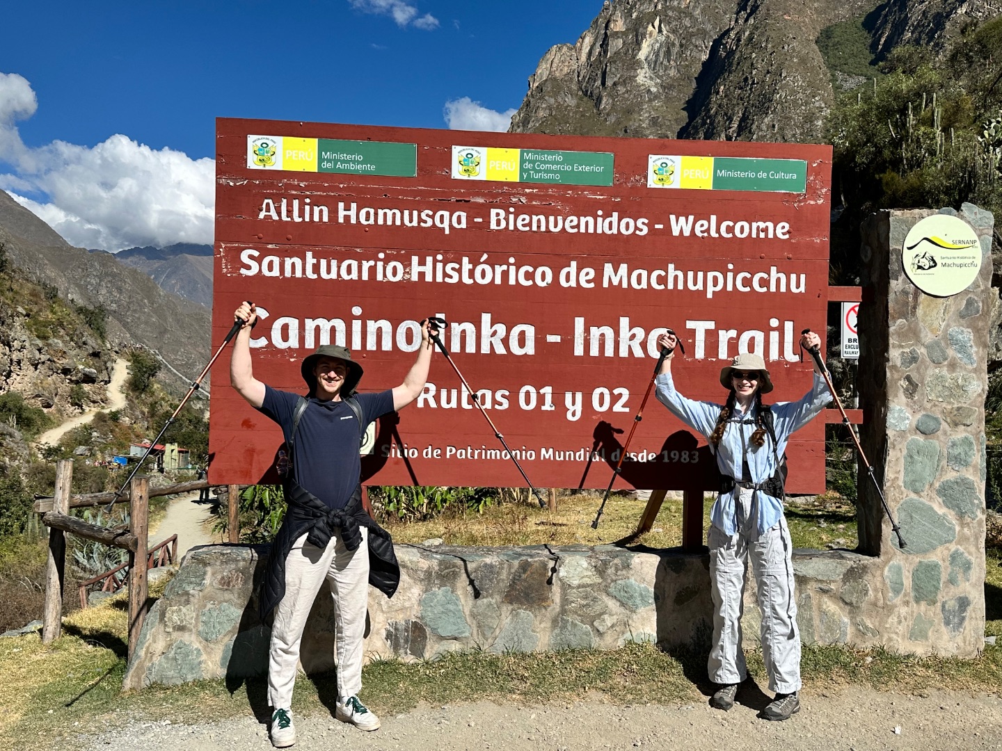 inca trail: start sign, arms up