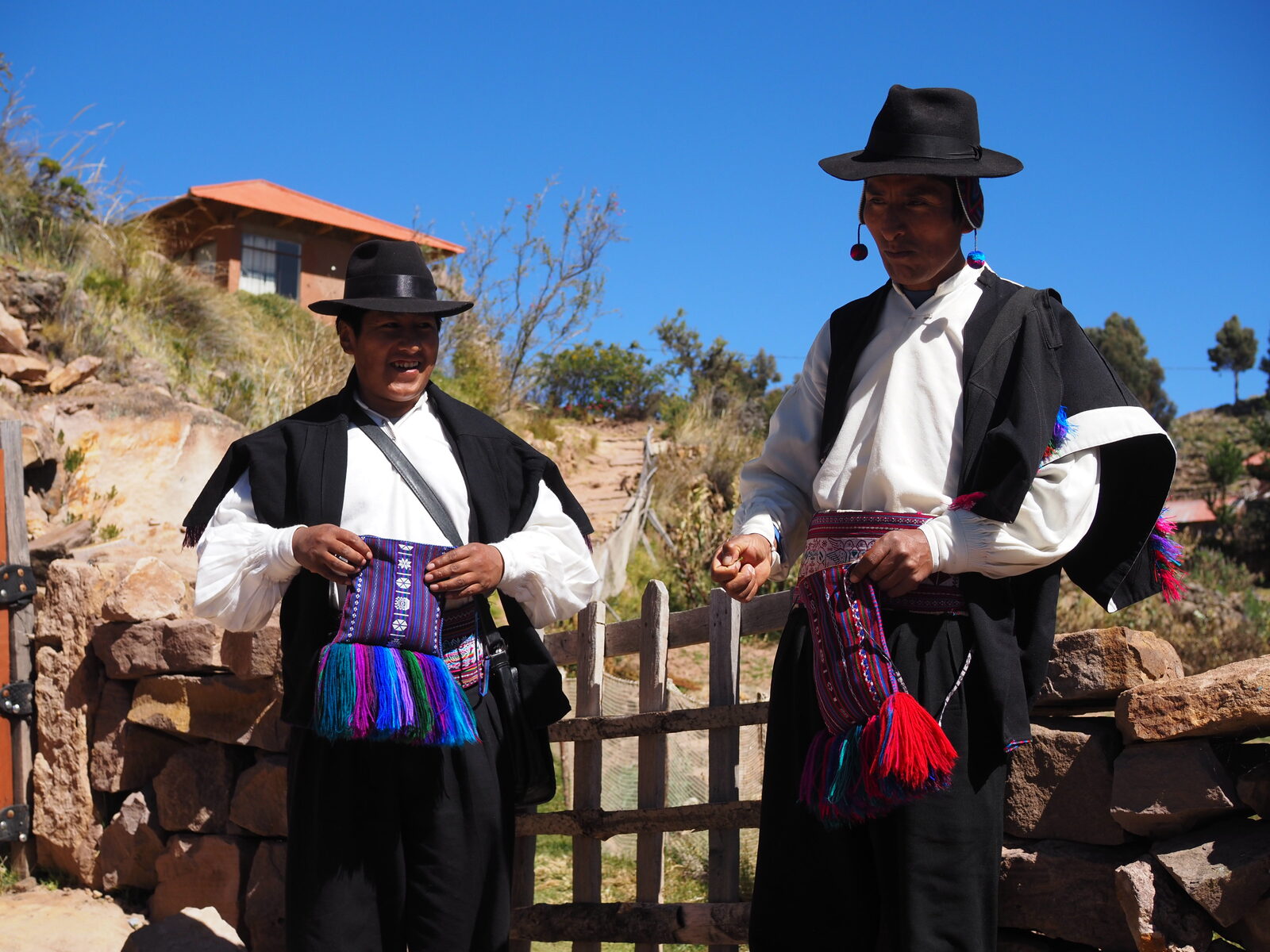peru: two men in traditional Taquile dress